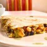 An Avocado black bean quesadilla on a white plate.