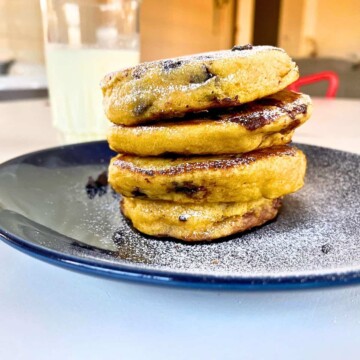 A stack of Pumpkin chocolate chip pancakes on a blue plate.