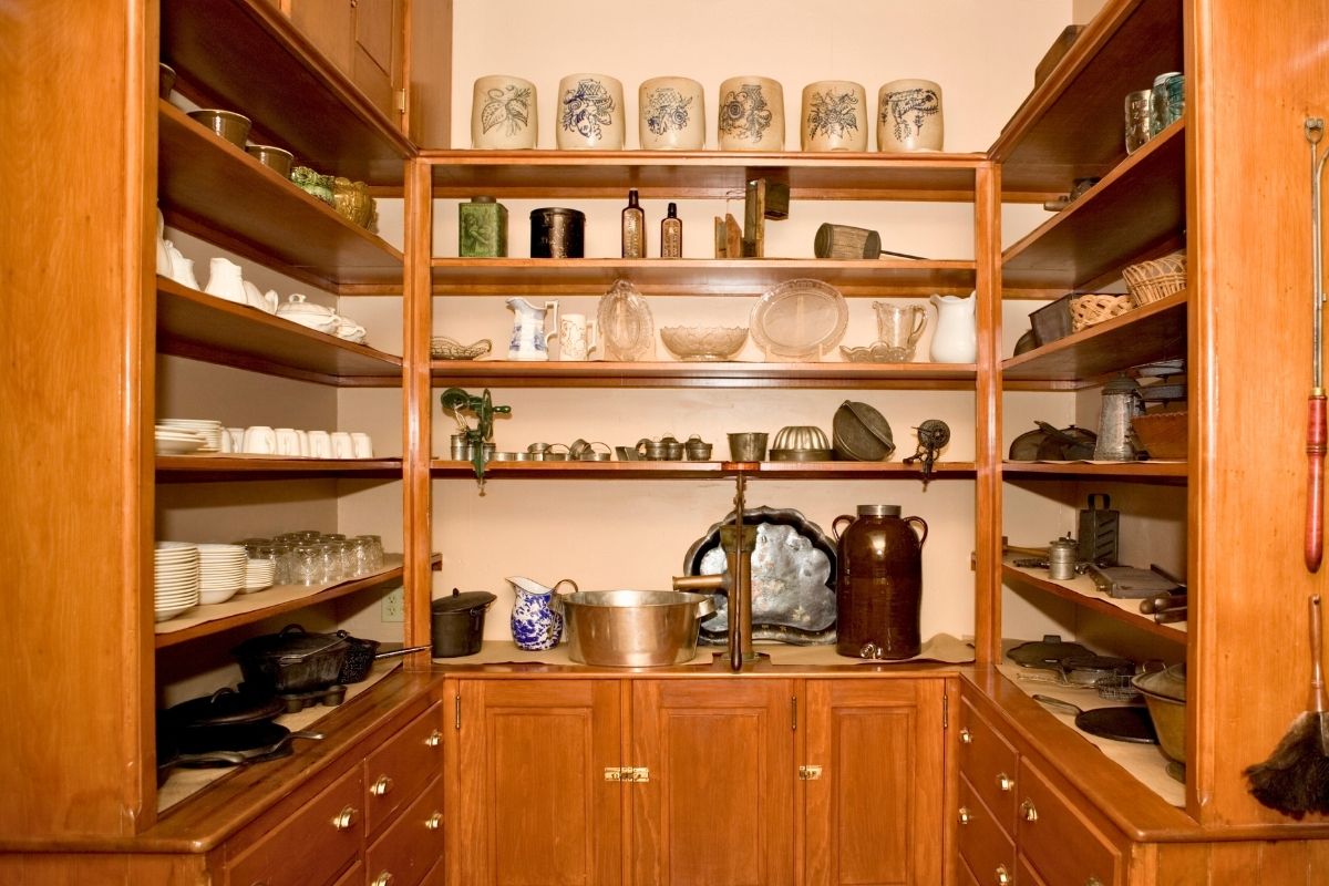 A wooden pantry room with shelves.