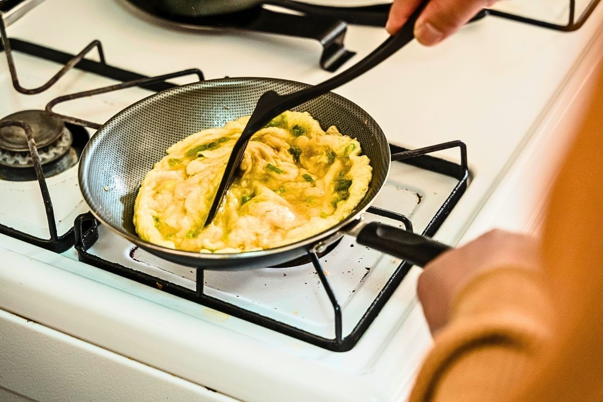 Watery srambled eggs in a pan.