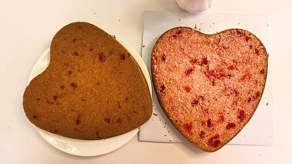 Two heart shaped cakes on a white plates.