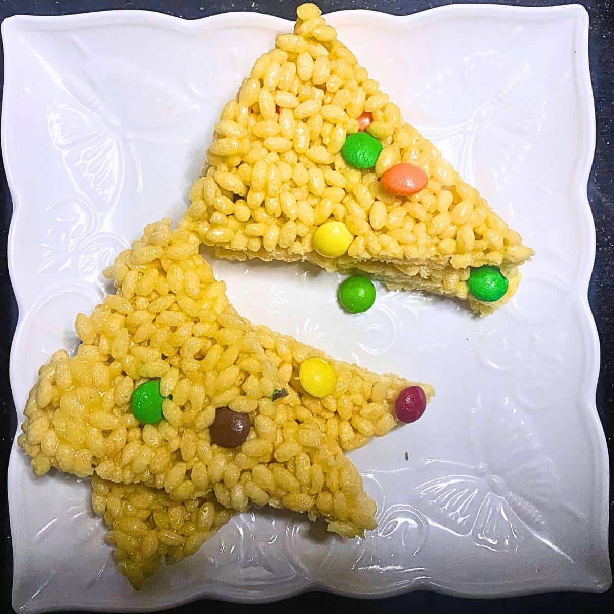M and M Marshmallows Rice Krispies Treats on a white plate.