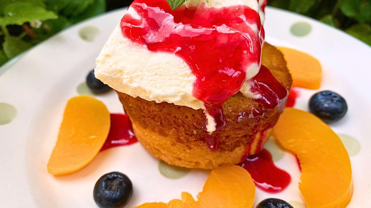 Mastro butter cake on a white plate with cream and fruits.