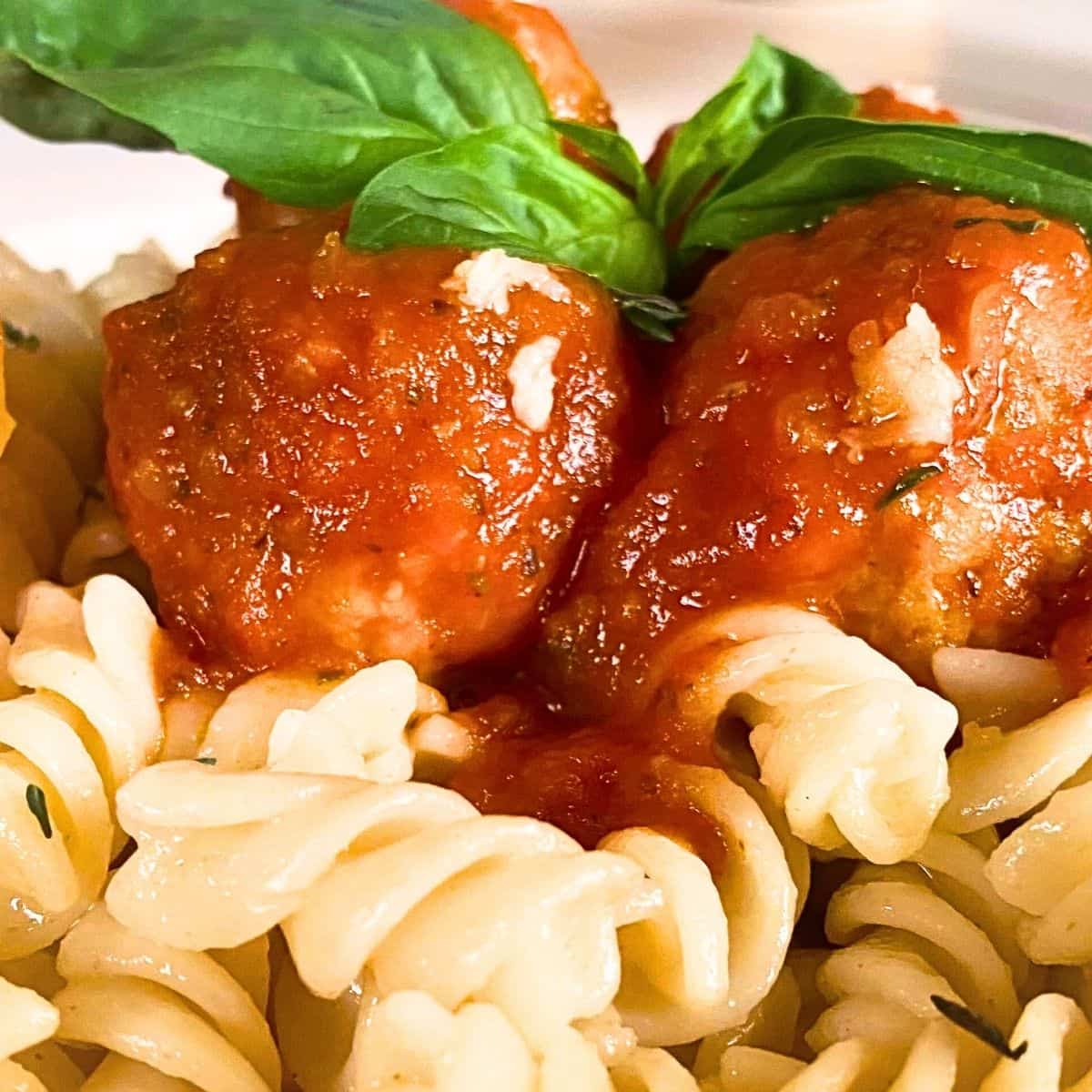 A close up of meatballs and pasta.