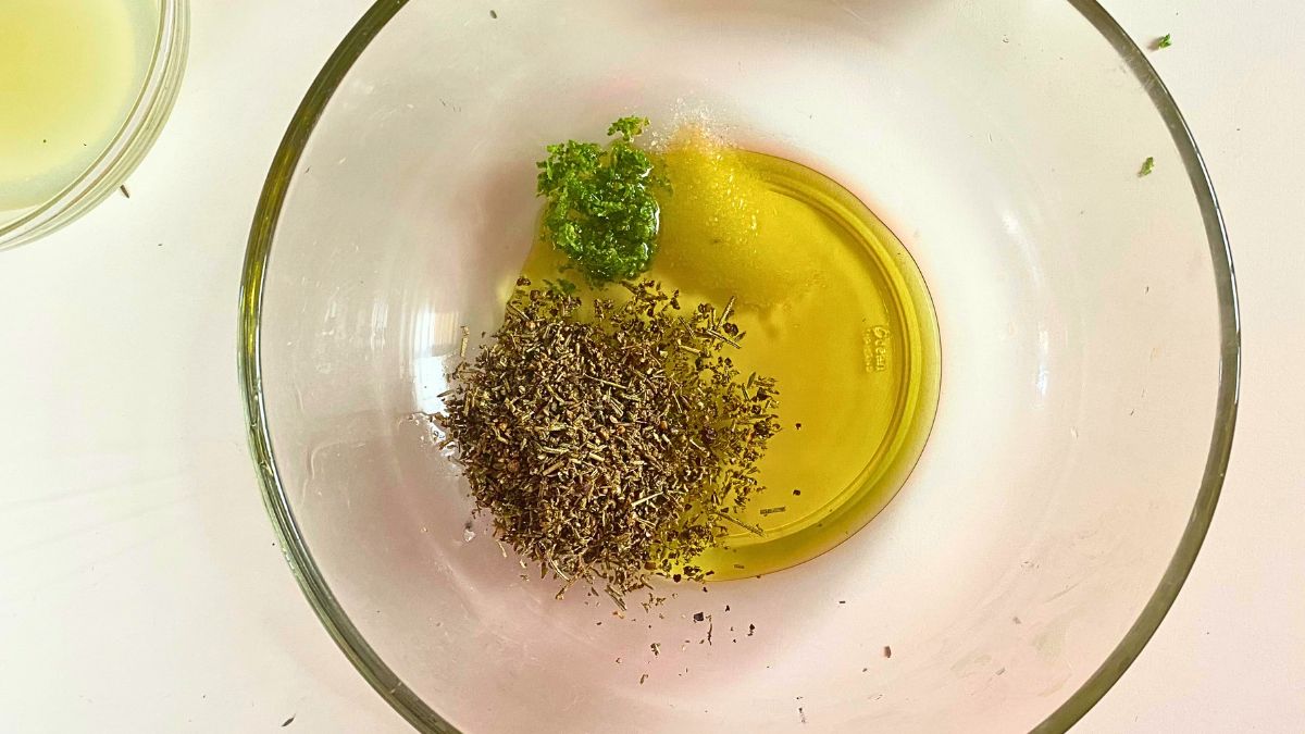 A bowl of oil and herbs.