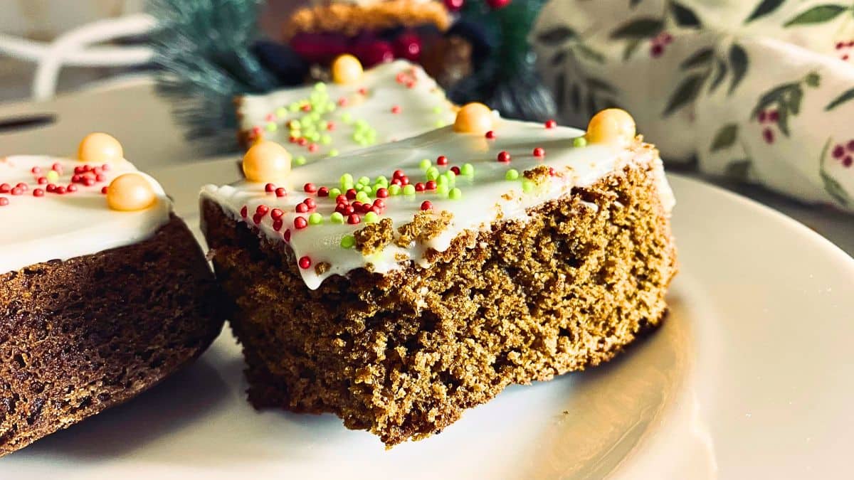 Two decorated gingerbread brownies on a white plate.