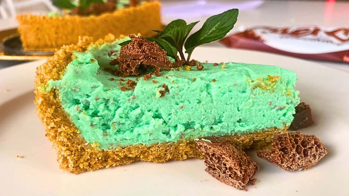 A close up of a slice of mint chocolate aero cheesecake.