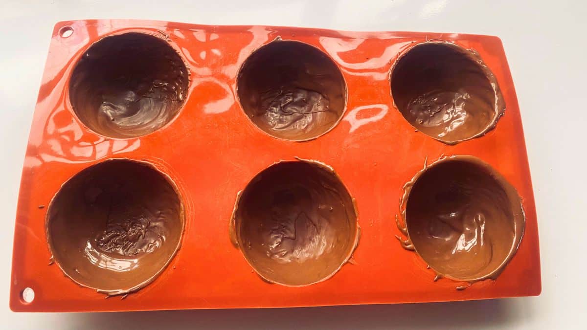 A red mold of chocolate bombs.
