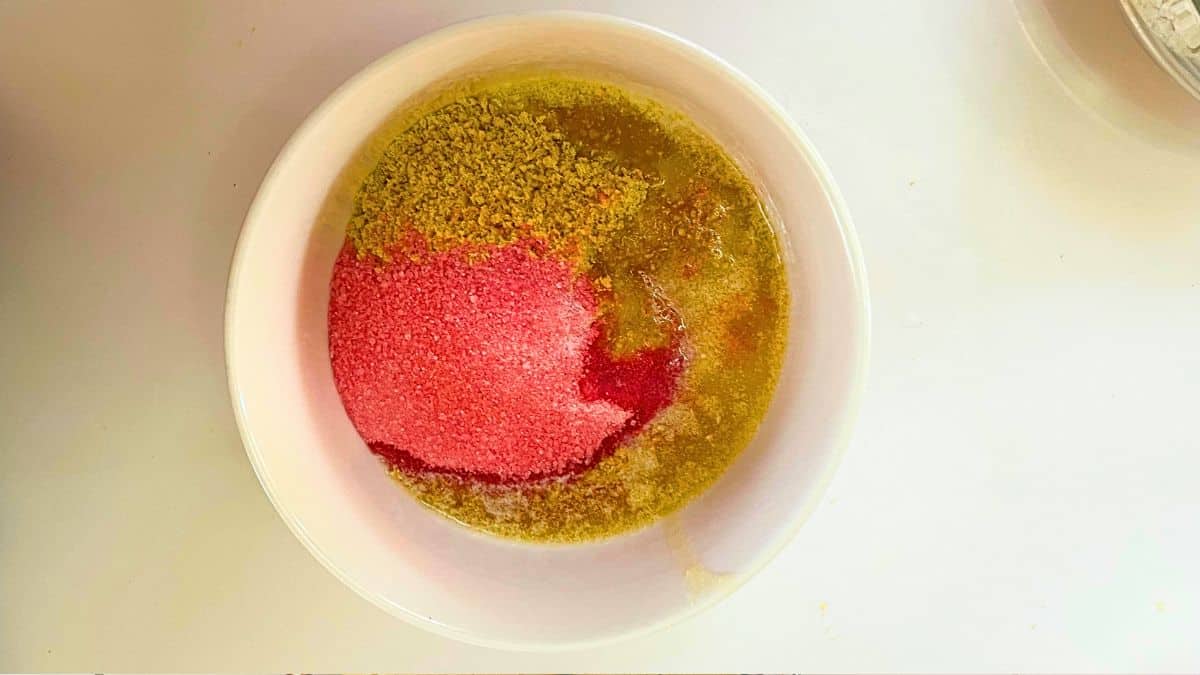 A bowl of food with a red and yellow substance.