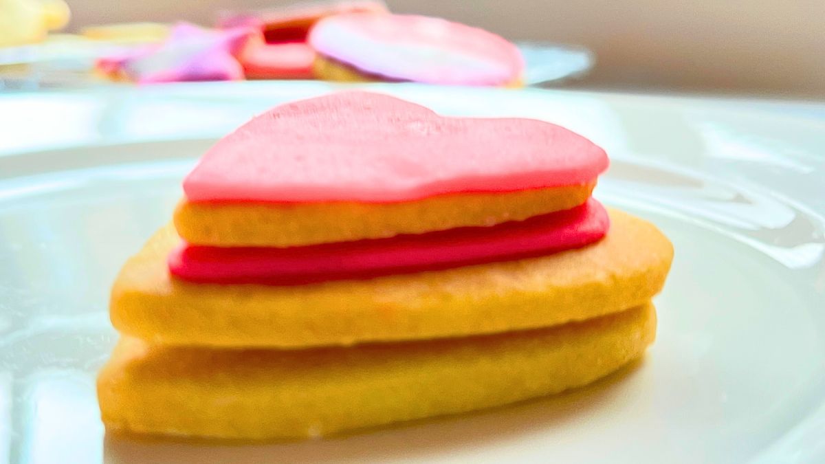 A stack of pink heart shaped cookies.